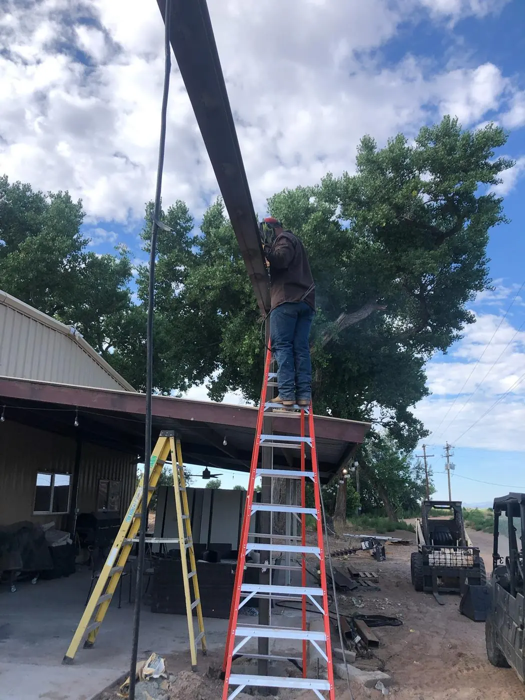 Welding a beam overhead from a ladder