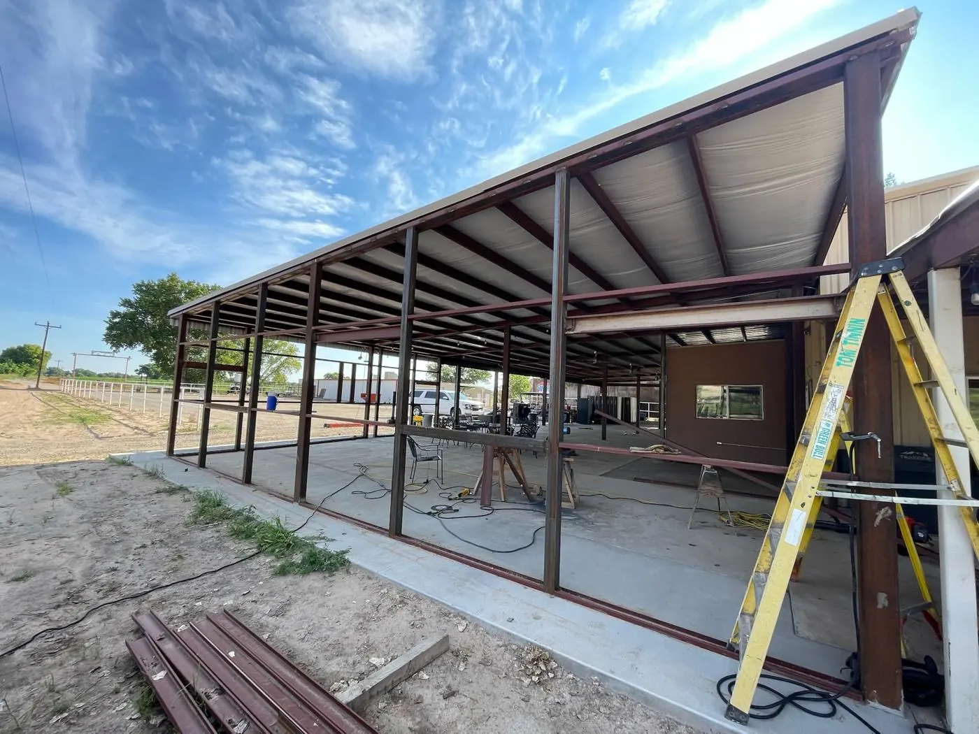 Steel wall framing under a metal roof